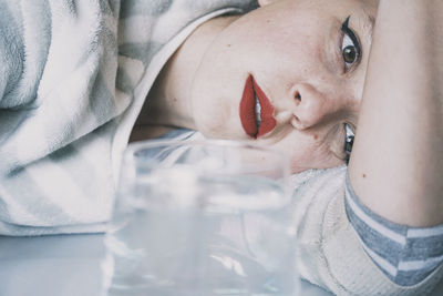 Close-up of woman lying down on floor