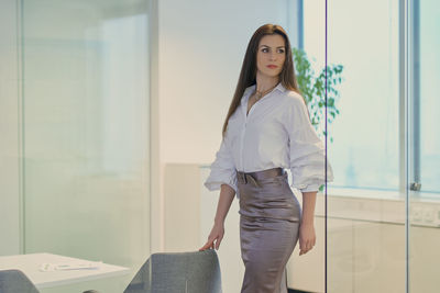 Businesswoman looking away while standing in office