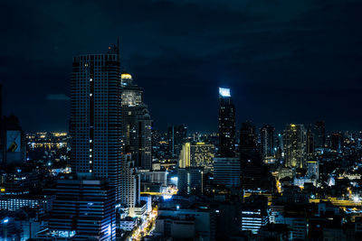 Illuminated cityscape against sky at night