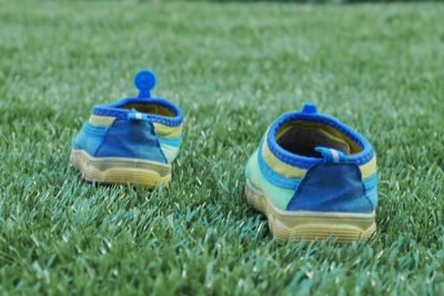 Close-up of shoes on field