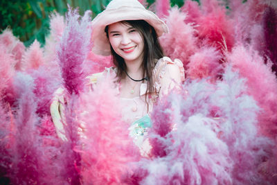 Portrait of smiling young woman in pink hair