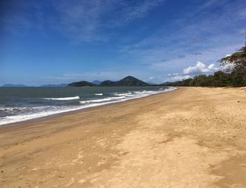 Scenic view of beach against blue sky