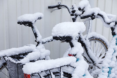 Snow-covered bikes next to each other