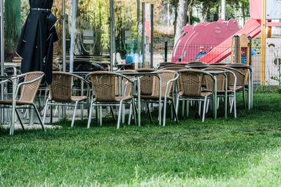 Empty chairs and table in park