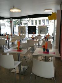 Empty chairs and tables in restaurant