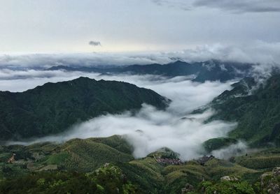 Scenic view of mountains against cloudy sky