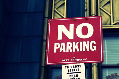 Low angle view of no parking sign outside building