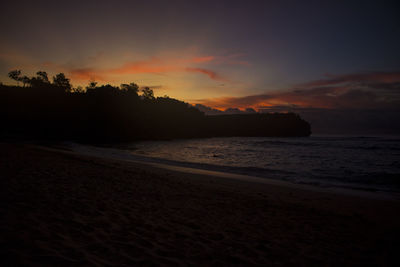 Scenic view of beach against sky during sunset