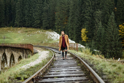 Man standing on railroad track