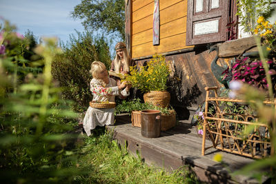 Rear view of woman standing by plants