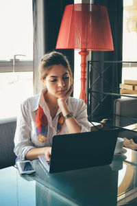 Businesswoman using laptop at desk