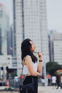 Side view of woman looking at city