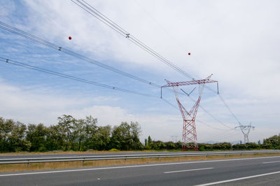 Low angle view of power lines against sky