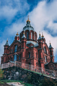 Low angle view of building against cloudy sky