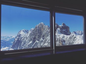 Scenic view of snowcapped mountains seen through window