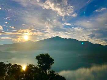 Scenic view of silhouette mountains against sky at sunset