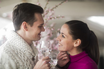 Young couple inside drinking wine