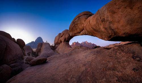 Rock formations on mountain against clear sky