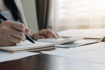 Cropped image of woman holding table