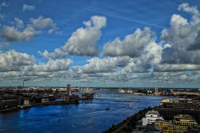 High angle view of buildings by sea against sky