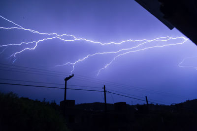 Low angle view of lightning against sky at night