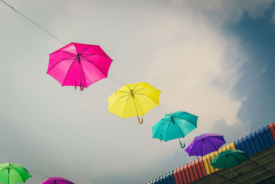 Low angle view of pink umbrella against sky