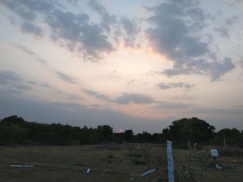 Scenic view of field against sky at sunset