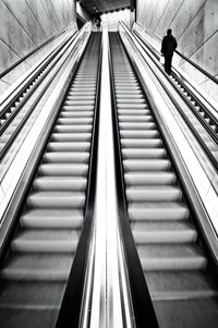 Low angle view of people on escalator at subway station