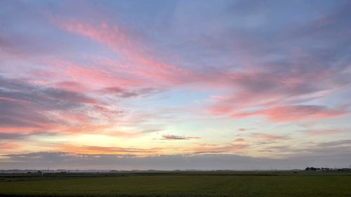 Scenic view of field against sky during sunset