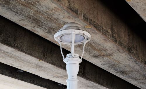 Low angle view of streetlight under bridge