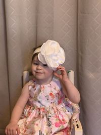 Portrait of a girl holding flower head