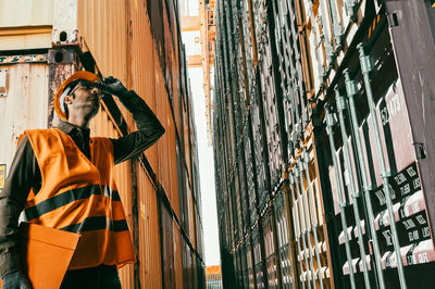 Low angle view of man standing against building