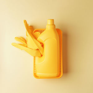 High angle view of yellow bottle against white background