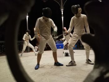 Rear view of people walking on street at night