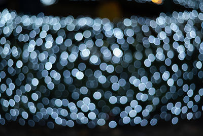 Defocused image of illuminated christmas lights at night