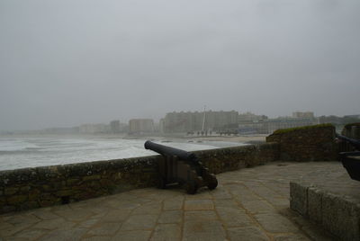 Empty bench overlooking calm sea