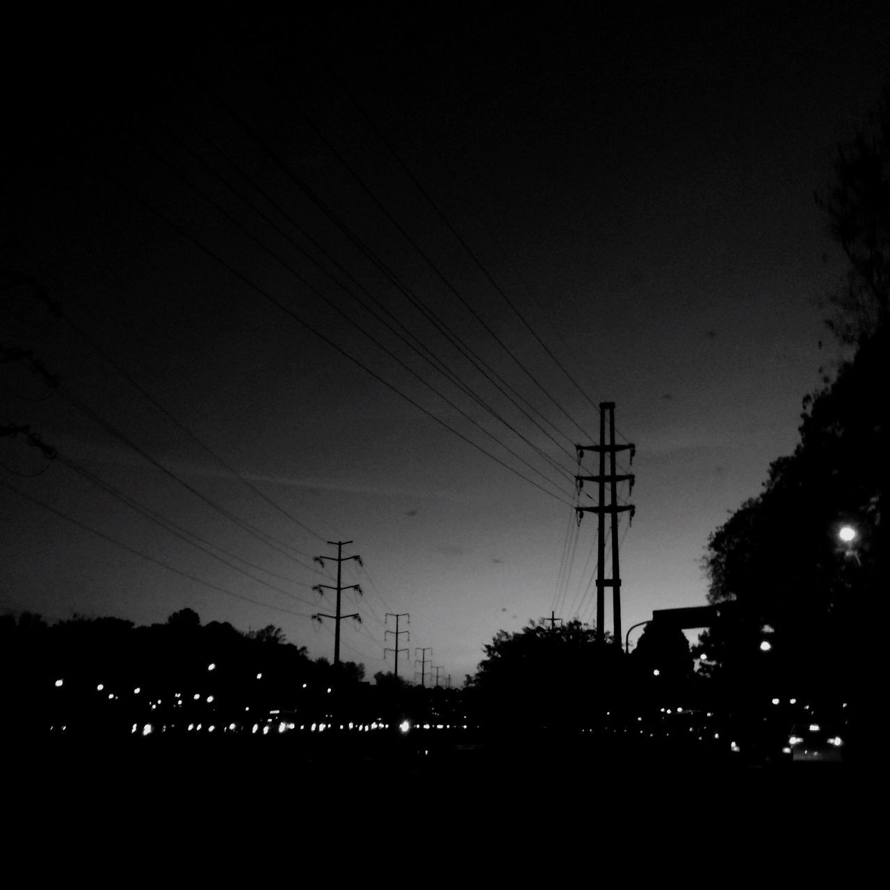 electricity, electricity pylon, power line, connection, fuel and power generation, power supply, silhouette, technology, cable, low angle view, illuminated, sky, night, electricity tower, growth, dark, electric light, nature, tranquil scene, tranquility, no people, scenics