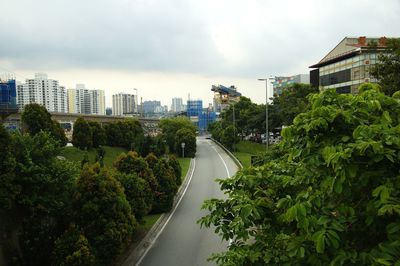 High angle view of road amidst buildings against sky