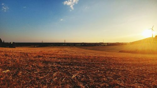 Scenic view of field against sky during sunset