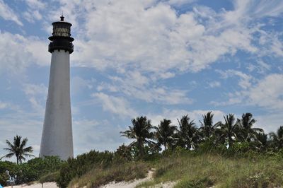 Low angle view of lighthouse against cloudy sky