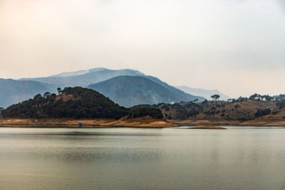 Lake calm water with mountain background at day from flat angle