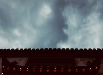 Low angle view of illuminated building against sky