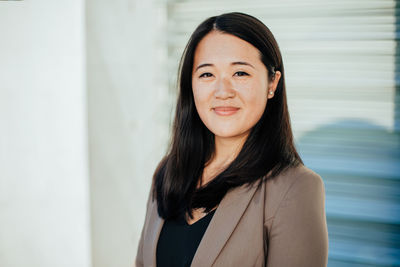 Portrait of smiling businesswoman standing in office