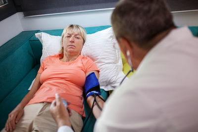 Male doctor examining female patient