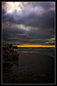 Scenic view of sea against cloudy sky