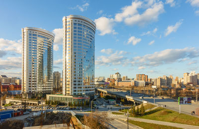 Modern buildings in city against sky