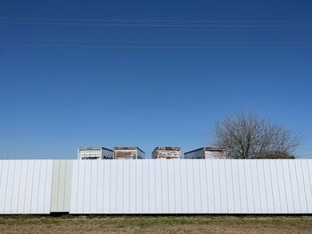 Built structure on field against clear blue sky
