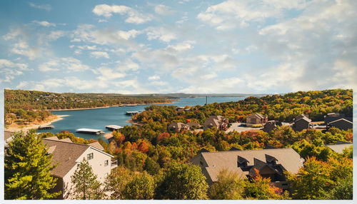 High angle view of townscape by sea against sky