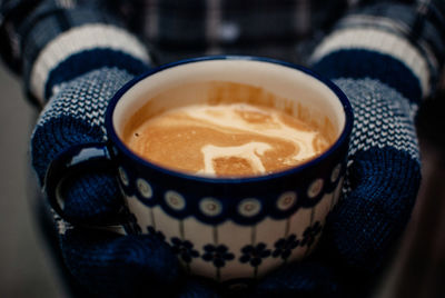 Cropped image of person holding coffee