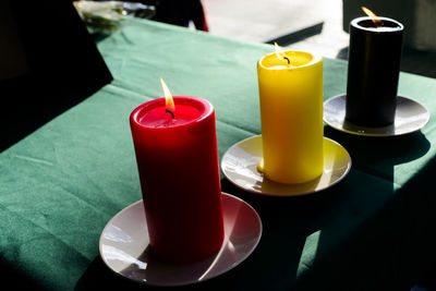 View of candles burning on table